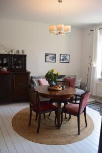 a living room with a table and chairs and a couch at Martinsgarten in Angermünde