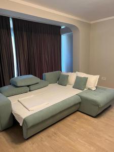 a large bed in a room with two pillows at Apart Central in Orşova