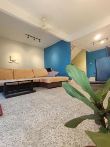 a living room with a couch and a tv at AL Cozy Seri Kuantan Home in Kuantan