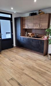 a kitchen with wooden cabinets and a large window at Maison La Bonbonnière chaleureuse avec parking et garage gratuit proche frontière in Forstfeld