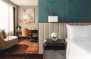 a bedroom with a bed and a desk and a chair at InterContinental Bangkok by IHG in Bangkok