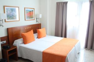 Ein Bett oder Betten in einem Zimmer der Unterkunft Hotel Pujol