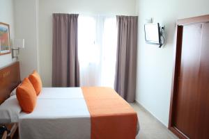Ein Bett oder Betten in einem Zimmer der Unterkunft Hotel Pujol