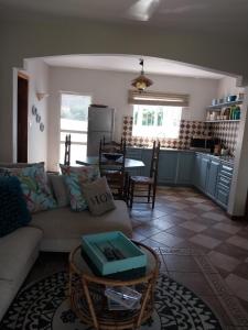a living room with a couch and a table at CHILLpill Guest House in Mahébourg