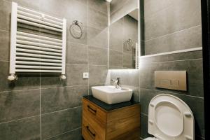 a bathroom with a toilet and a sink at Flat w Jacuzzi 2 min to Metro Near Marmara Park in Istanbul