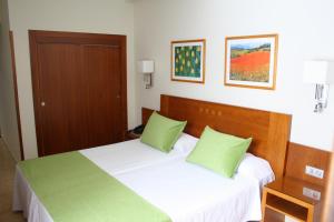 Ein Bett oder Betten in einem Zimmer der Unterkunft Hotel Pujol