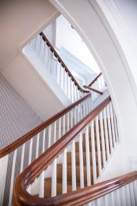 an open staircase with wooden railings in a house at Stella Maris in Svendborg