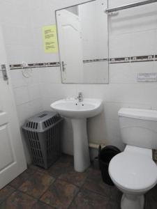 a bathroom with a sink and a toilet and a mirror at Marlicht Vacation Resort in Margate