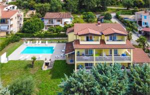 an aerial view of a house with a swimming pool at Amazing Apartment In Porec With 1 Bedrooms, Wifi And Outdoor Swimming Pool in Poreč
