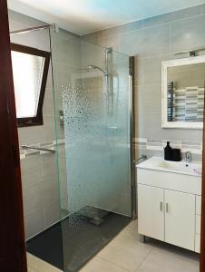 a bathroom with a glass shower and a sink at Villa Costera B&B in Sant Antoni de Calonge