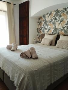 a bedroom with a large bed with towels on it at Villa Costera B&B in Sant Antoni de Calonge
