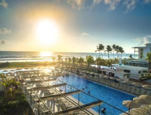 an image of a resort with a pool and the ocean at Riu Sri Lanka All Inclusive in Bentota