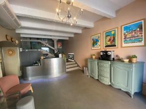 a hair salon with a waiting room with a counter and chairs at The Originals Boutique, Hôtel Cassitel, Cassis in Cassis