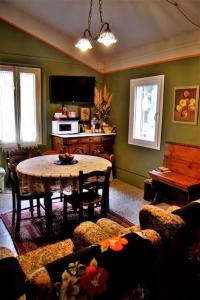 a living room with a table and a piano at Casa Fiorenza in Montefelcino +23 photos