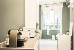 una cocina con una máquina de coser en una barra con ventana en Margreth Apartment, en Milán