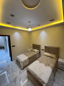 a bedroom with two beds and a ceiling at Selouane in Nador