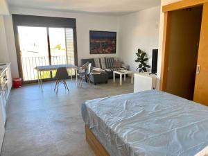 a bedroom with a bed and a living room at Modern Loft in Terrassa in Terrassa