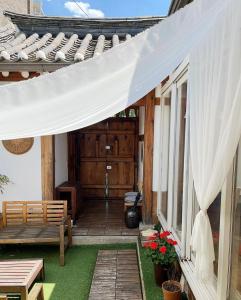 a patio with a white canopy on a house at SeoulStory Hanok in Seoul