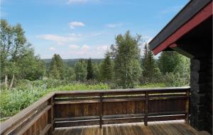 a wooden deck with a view of the woods at Beautiful Home In Nord-torpa With House A Mountain View in Nord Torpa