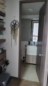 a bathroom with a sink and a window and a door at Apartamento en Sabaneta in Sabaneta