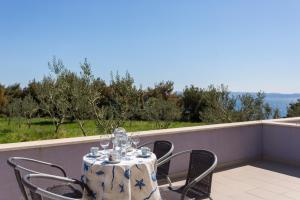 a table and chairs on a balcony with a view of the ocean at Adriatic Queen Residence in Split