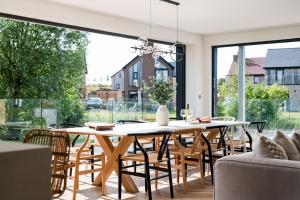 a dining room with a table and chairs and a large window at Serenity WI27 - Silverlake - Dorset in Warmwell