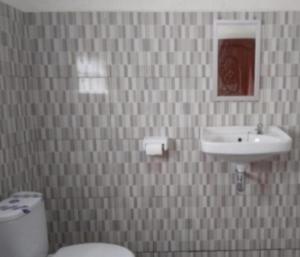 a bathroom with a toilet and a sink at Mushtinal Guest House in Ende +37 photos