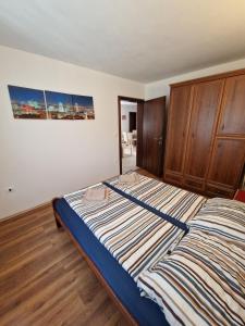 a bedroom with a large bed with a wooden cabinet at Villa Luka in Barbariga