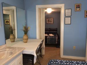 a bathroom with a table and a sink and a mirror at The New Oceanic Inn in Old Orchard Beach +37 photos