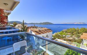 a balcony with a view of the water at Antiphellos Pension Küçükçakıl in Kas