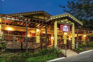 a restaurant with a lit up sign in front of it at Alpine Breeze at Crosswinds Tagaytay in Tagaytay