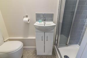 a bathroom with a sink and a toilet and a shower at Stay @ Baker Street Derby in Derby