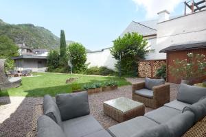 a patio with a couch and chairs in a yard at Ferienhaus Apple Tree in Treis-Karden