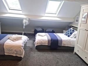 two beds in a room with two windows at Hafan Artro in Llanbedr