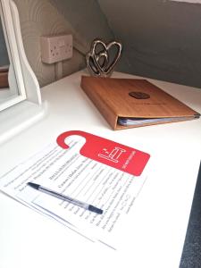 a piece of paper on a table with a pair of scissors at Hafan Artro in Llanbedr