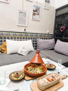 a table with plates of food on top of it at Boho 27 Hostel Marrakech in Marrakesh