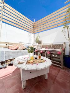 a living room with a table with food on it at Boho 27 Hostel Marrakech in Marrakech