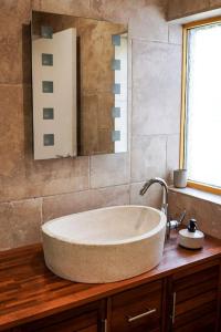 a bathroom with a large tub on a wooden counter at Villa spacieuse et accueillante in Mons