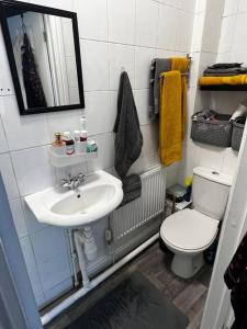 a small bathroom with a sink and a toilet at Luton Airport £40 per night, best value in Luton
