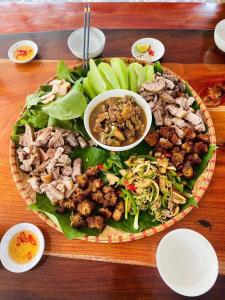 a platter of food on a wooden table at Hà Lù Homestay in Lao Cai