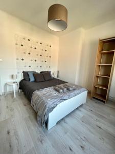 ein Schlafzimmer mit einem großen Bett in einem Zimmer in der Unterkunft Appartement 6/8 pers Plage à 10min NETFLIX in Dunkerque