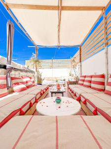 a room with red and white couches and a table at Boho 27 Hostel Marrakech in Marrakesh