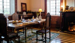a dining room with a table and a fireplace at Torres da Vila in Anadia