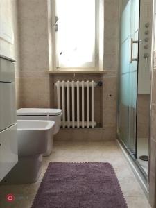 a bathroom with a toilet and a sink and a window at Villa al mare in Senigallia