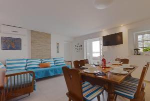 a living room with a table and a blue couch at Holiday Home Marija in Dramalj