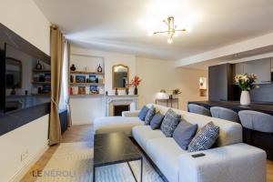 a living room with a couch and a fireplace at The Neroli Elegant and spacious ideally located in Grasse