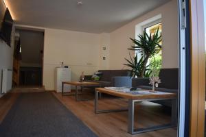 a living room with two tables and a couch at Ferienhaus Haueis in Tumpen