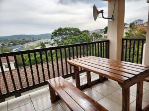 a wooden bench sitting on top of a balcony at Asher's Place in East London