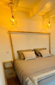 a bedroom with a large bed with two pillows at Tiny House Noordwijk aan Zee in Noordwijk