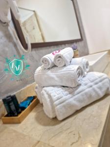 a stack of towels on a counter in a bathroom at Hotel AquaMarine in Costinesti